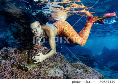 Mermaid swimming underwater in the deep blue sea Mermaid swimming underwater in the deep blue sea 29685439