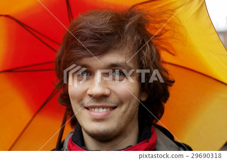 Man with Smile in the Rain with an Orange Umbrella Man with Smile in the Rain with an Orange Umbrella 29690318