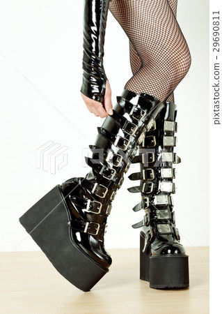 woman wearing extravagant clothes and boots woman wearing extravagant clothes and boots 29690811
