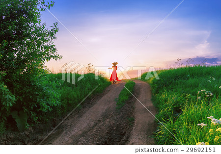 Young Woman Dancing Against The Setting Sun 29692151