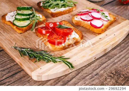 Four sandwiches with fresh vegetables, tomatoes Four sandwiches with fresh vegetables, tomatoes 29692294