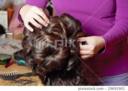 Professional Wig Maker Working in her Workshop. Professional Wig Maker Working in her Workshop. 29692901