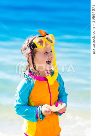 Child snorkeling on tropical beach Child snorkeling on tropical beach 29694072