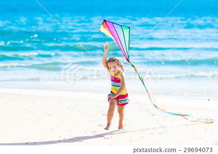 Child flying kite on tropical beach Child flying kite on tropical beach 29694073