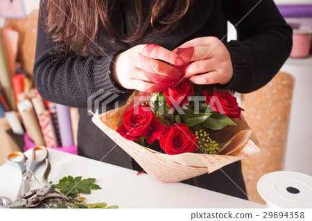 Florist making bouquet of red roses Florist making bouquet of red roses 29694358