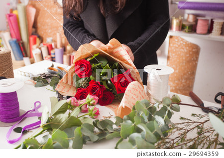 Florist making bouquet of red roses Florist making bouquet of red roses 29694359