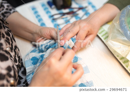 Female manicure on hands in a beauty salon 29694671