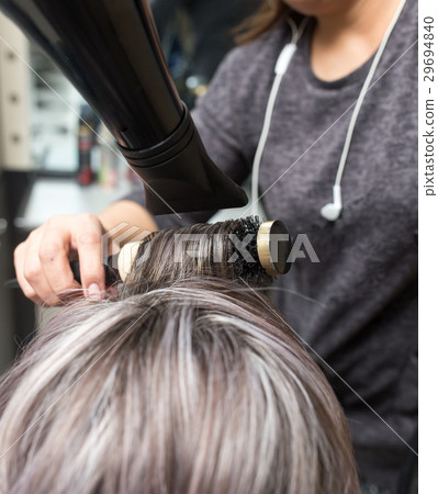 Styling female hair dryer in the beauty salon 29694840