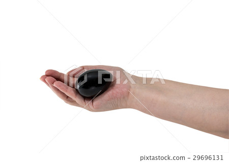 Hand holds a black egg 29696131