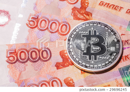 One Bitcoin on Russian rubles banknotes. One Bitcoin on Russian rubles banknotes. 29696245