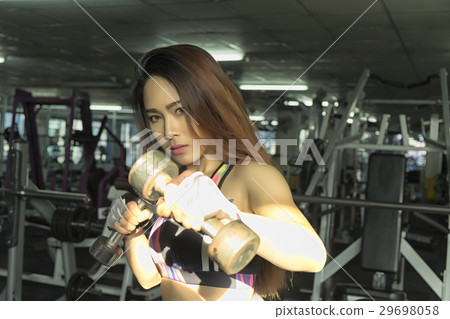 Fitness woman in training showing exercises in gym 29698058