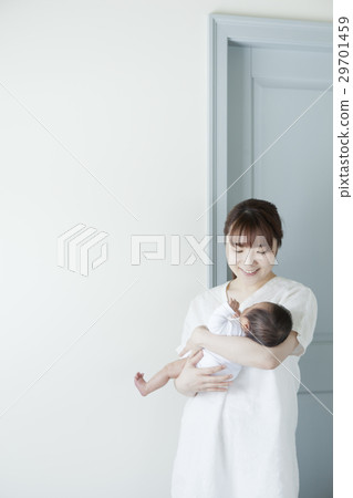 Mother holding a newborn baby 29701459