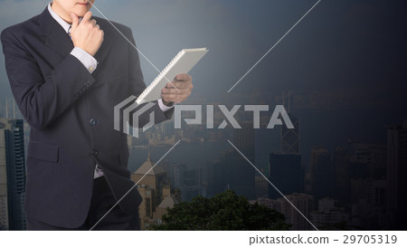 Confident Asian businessman reading notebook or Confident Asian businessman reading notebook or 29705319