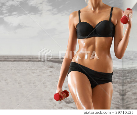 Sexy, athletic, blonde woman in the gym, against Sexy, athletic, blonde woman in the gym, against 29710125