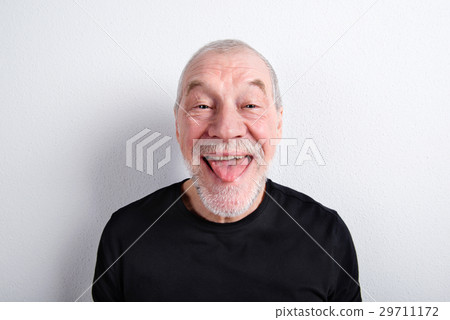 Senior man making funny face, sticking tongue out 29711172