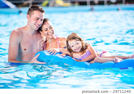 Mother, father and daughter in swimming pool Mother, father and daughter in swimming pool 29711240