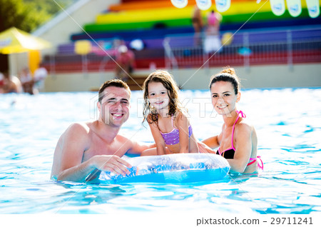 Mother, father and daughter in swimming pool Mother, father and daughter in swimming pool 29711241