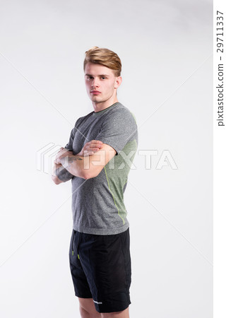 Handsome man in gray t-shirt, tattoo on forearms 29711337