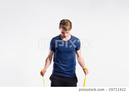 Fitness man working out with resistance bands 29711422