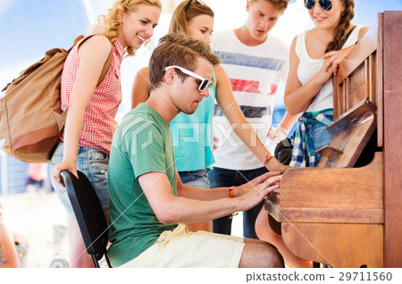 Teenagers at summer music festival, boy plays the 29711560