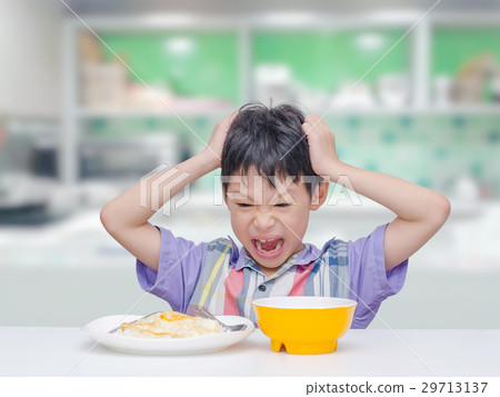 Asian child don't want to eat food for lunch 29713137
