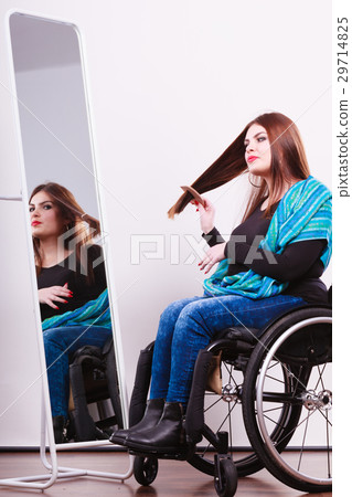Disabled girl looking at mirror. 29714825