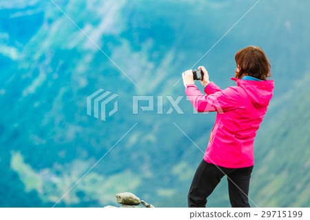 Tourist taking photo from Dalsnibba, Norway Tourist taking photo from Dalsnibba, Norway 29715199