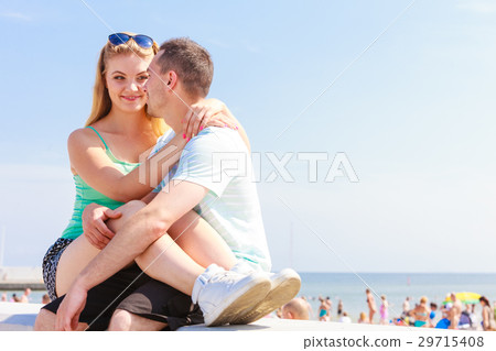 Man and woman sitting together outside Man and woman sitting together outside 29715408