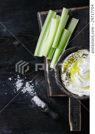 Fresh celery with yogurt dip 29717704