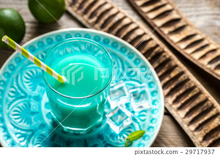 Glass of blue curacao and juice cocktail 29717937