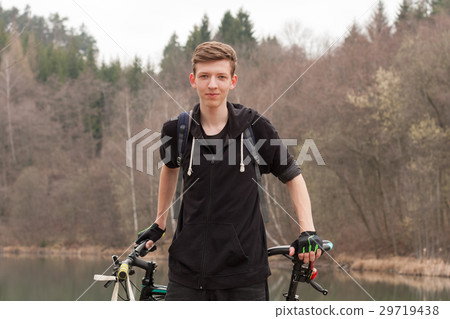 Young man on mountain bike relaxes 29719438