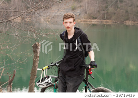Young man on mountain bike relaxes 29719439