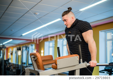 Focused man doing dips in the gym 29719803