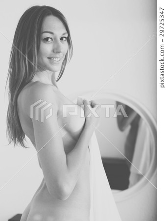 nude woman with mirror in bedroom 29725347