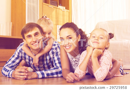 Relaxed family of four posing Relaxed family of four posing 29725958