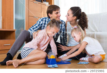 Parents playing lotto with kids. Parents playing lotto with kids. 29725991