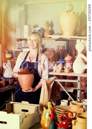 Young woman carrying ceramic vessels 29726099