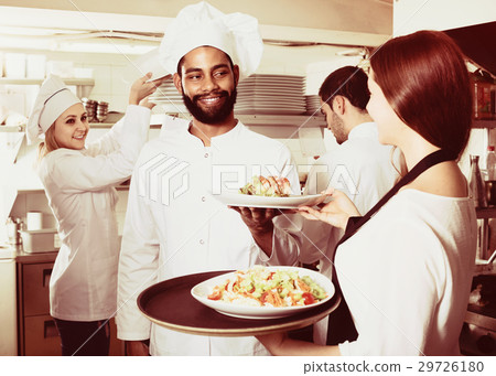 Waitress and cooking team in restaurant 29726180