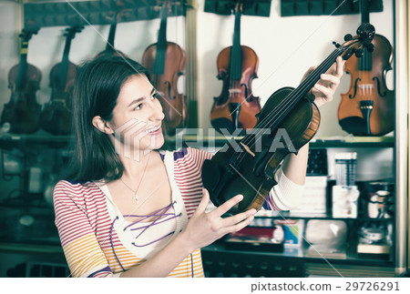 Teenage girl selecting classical violin 29726291