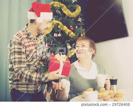 Mother and son exchanging Christmas gifts Mother and son exchanging Christmas gifts 29726408