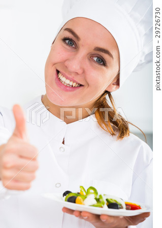 girl in chef's hat and white coat showing salad girl in chef's hat and white coat showing salad 29726730