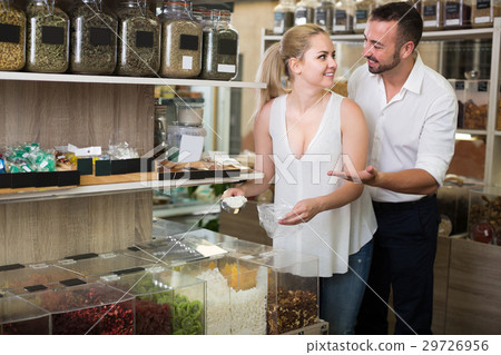 Young couple picking dried sweet fruits 29726956