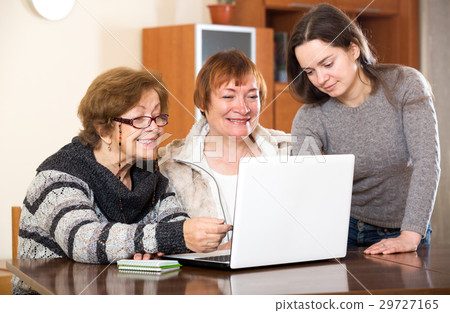 Cheerful girl helping senior women Cheerful girl helping senior women 29727165