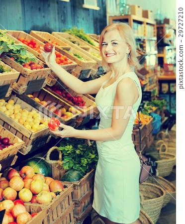 Portrait of woman buying fresh greens and fruits 29727210