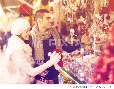 Couple choosing Christmas decoration 29727423