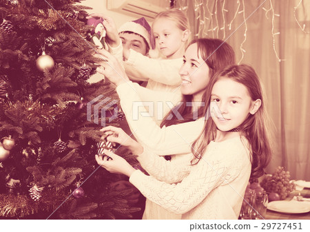 Family decorating Christmas tree at home Family decorating Christmas tree at home 29727451
