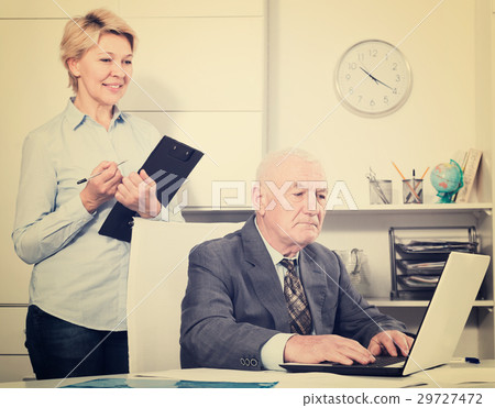 Aged manager working with secretary Aged manager working with secretary 29727472