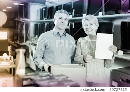 Smiling mature married couple buying on credit household appliances 29727815