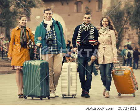 travelers with baggage sightseeing and smiling in autumn 29727821