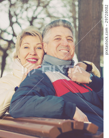 Smiling mature couple relaxing in park 29728082